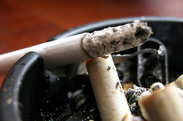 Image showing burning cigarrette on ashtray