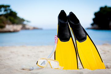 Image showing yellow fins and snorkelling mask on beach in summer