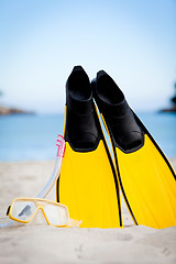 Image showing yellow fins and snorkelling mask on beach in summer