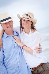 Image showing happy adult couple in summertime on beach 