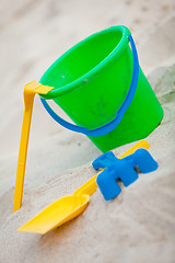 Image showing plastik colorful toys in sand on beach