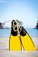 Image showing yellow fins and snorkelling mask on beach in summer