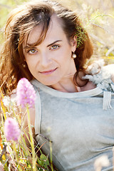 Image showing adult brunette woman smiling in summertime outdoor