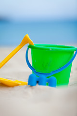 Image showing plastik colorful toys in sand on beach