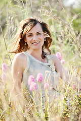 Image showing adult brunette woman smiling in summertime outdoor