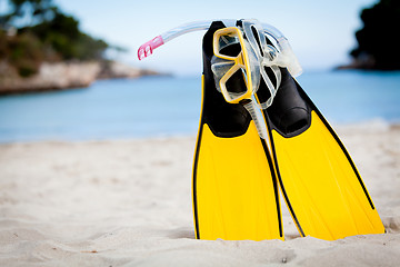 Image showing yellow fins and snorkelling mask on beach in summer