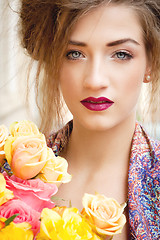 Image showing attractive young woman with pink roses
