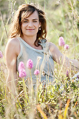 Image showing adult brunette woman smiling in summertime outdoor