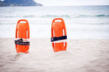 Image showing orange red life buoy in sand on beach at the sea object