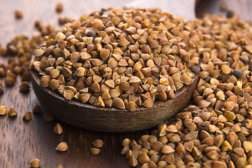 Image showing Buckwheat seeds on wooden spoon in closeup 