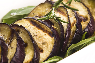 Image showing Grilled eggplant slices on a plate with fresh rosemary