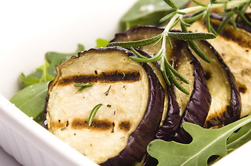 Image showing Grilled eggplant slices on a plate with fresh rosemary