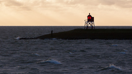 Image showing Silhouette of a red beacon at the dutch coast