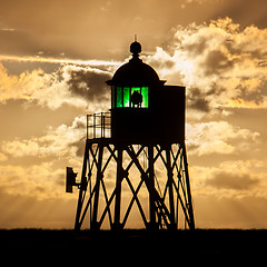 Image showing Silhouette of a green beacon at the dutch coast