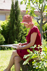 Image showing Aged woman reading book