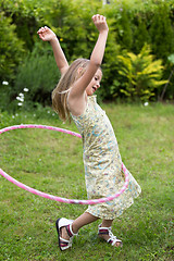 Image showing Little girl playing with hula hoop