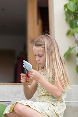 Image showing  Little girl cutting paper