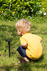Image showing Kid interested by solar battery
