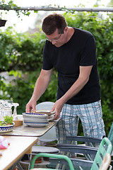 Image showing Man preparing plates