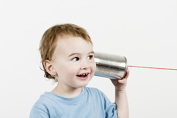 Image showing friendly child listening to tin can phone