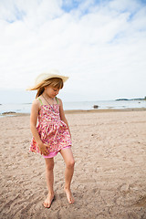 Image showing Young barefoot girl at beach