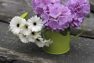 Image showing garden flowers in a watering-can