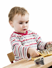 Image showing young child isolated in white background baking cookies