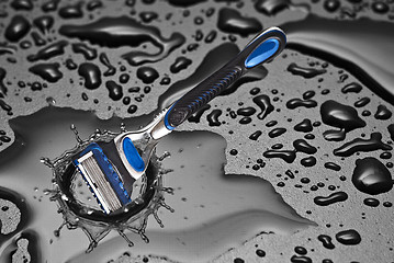 Image showing shaving razor inside a drop of water