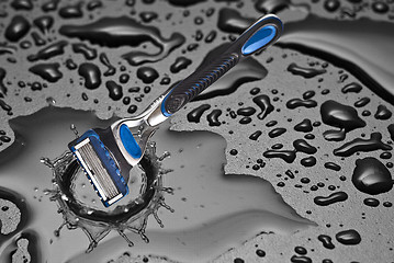 Image showing shaving razor inside a drop of water