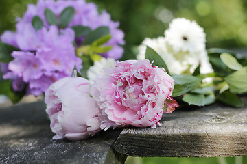 Image showing peonies and garden flowers on wooden planks