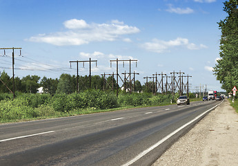 Image showing Wooden supports  electrical line along highway