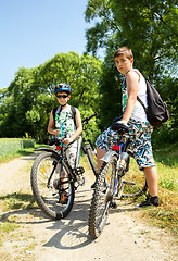 Image showing Two teenagers relaxing on a bike trip