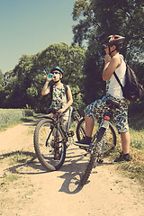 Image showing Two teenagers relaxing on a bike trip