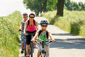 Image showing Mother with two sons on bicycle trip