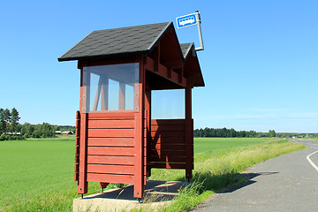 Image showing Wooden Bus Stop Shelter by Highway