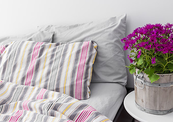 Image showing Bedroom decorated with bright purple flowers