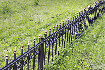 Image showing Metal fence on a grassy glade