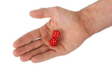 Image showing Hand holding red dices