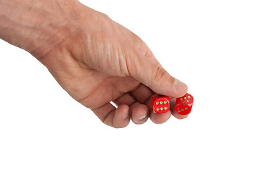 Image showing Hand holding red dices