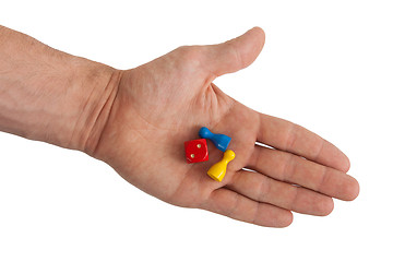 Image showing Hand holding two pawns