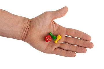 Image showing Hand holding two pawns