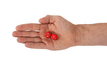 Image showing Hand holding red dices