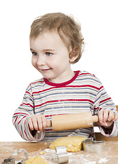 Image showing happy young child with rolling pin in white background