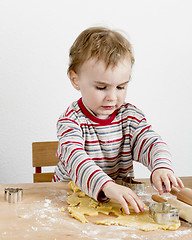 Image showing child at desk making cookies