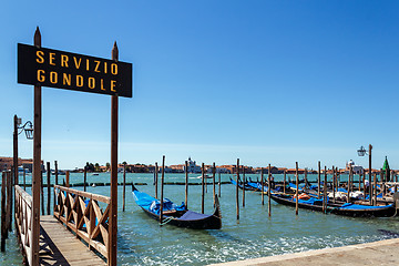 Image showing ITALY, VENICE - JULY 2012: Gondolas moor on July 16, 2012 in Venice. Gondolas are traditional flat-bottomed rowing boats that today mainly carry tourists.