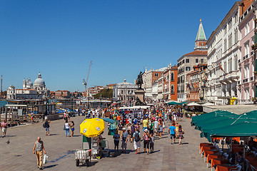 Image showing ITALY, VENICE - JULY 2012: Venice waterfront with crowd of tourist near St Marco Square on July 16, 2012 in Venice. St Marco Square is the largest and most f