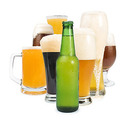 Image showing Mug filled with beer and bottles