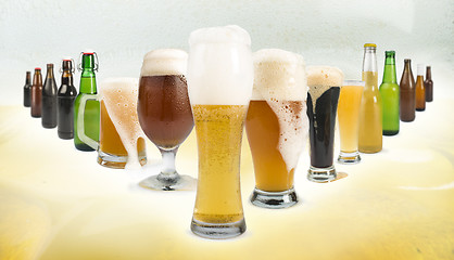 Image showing Mug filled with beer and bottles