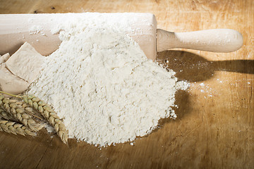 Image showing Pile of flour, rolling pin and wheat