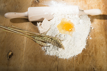 Image showing Pile of flour, rolling pin and wheat